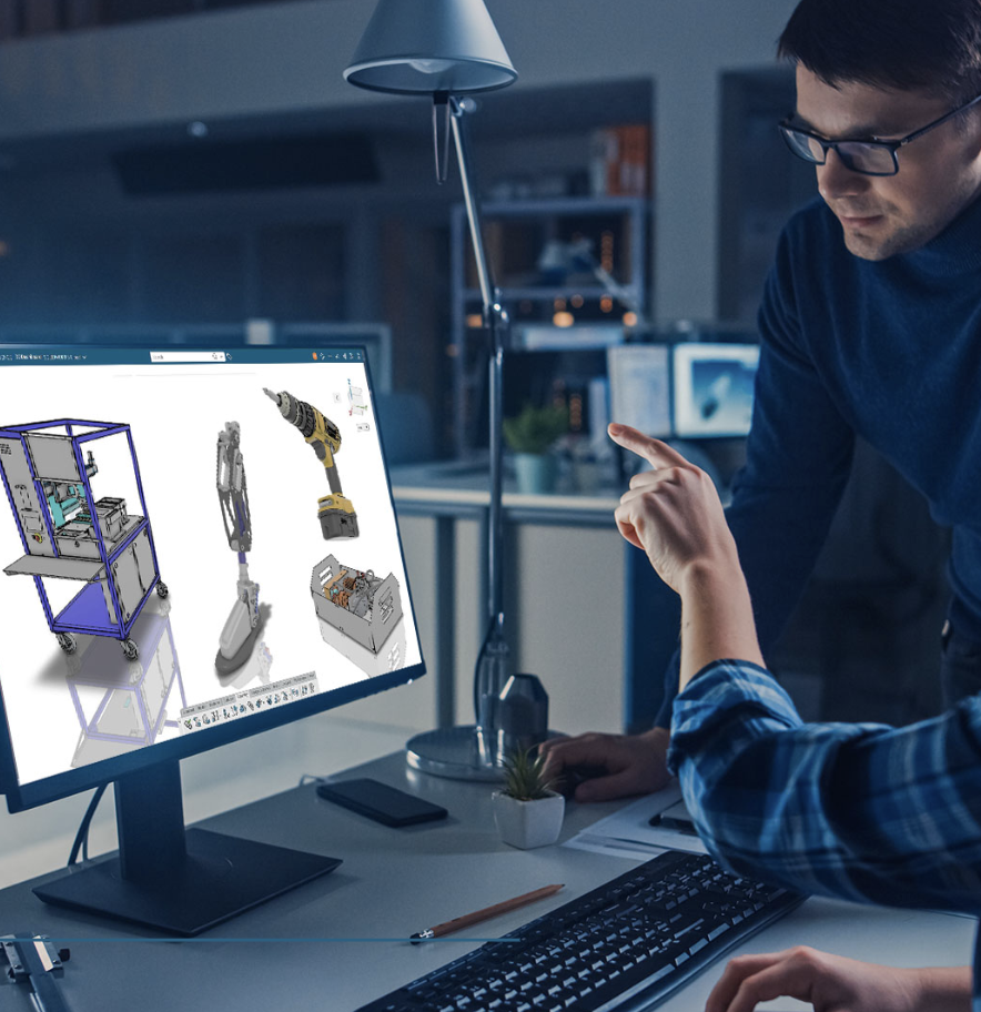 Engineers reviewing a mechanical prototype using CAD software on a computer workstation in a modern office.